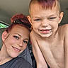woman, child, car, selfie, smile, tattoo, short_hair, mohawk, blue_eyes, casual_clothing, shirtless, indoor, seat, person, hair_up, happy, family, portrait, closeup, natural_light