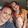 Alyssa joined the competition — help win amazing prizes! woman, child, car, smile, red_hair, tattoo, casual_clothing, portrait, happy, family, inside_vehicle, child_playing, person, seat, seatbelt, shorts, yellow_shirt, flower_pattern, barefoot, natural_light