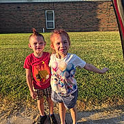 Alyssa joined the competition — help win amazing prizes! child, children, boy, girl, shorts, tshirt, sneakers, sidewalk, grass, building, brick_wall, window, sunlight, shadows, smiling, hairstyle, outdoor, friendship, happy, posing