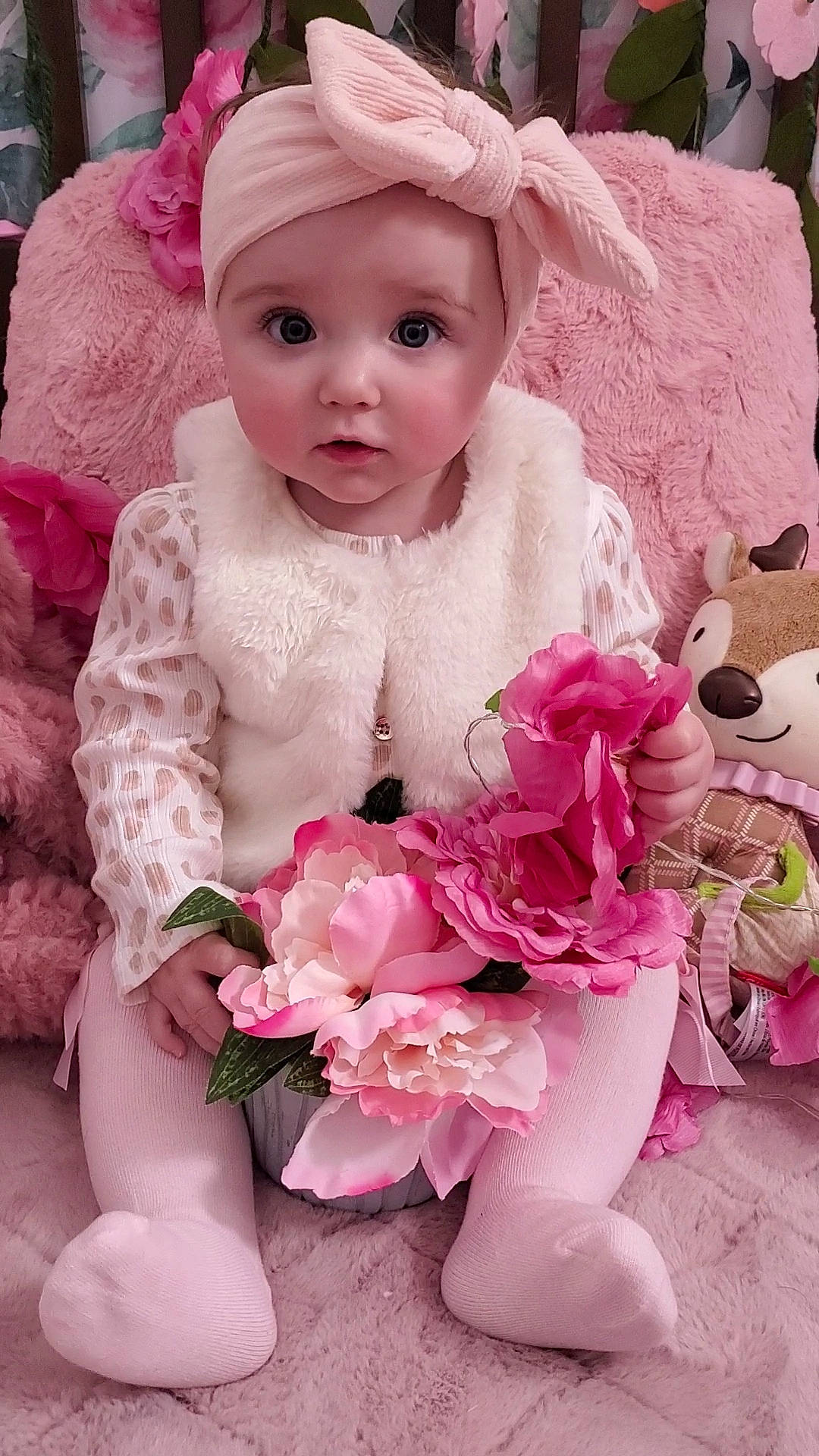 Aria is registered to the contest to win money with this photo: baby, baby_toddler_clothing, cap, dress, embellishment, flower, happy, headgear, headwear, hybrid_tea_rose, magenta, person, petal, photograph, pink, plant, rose, skin, sleeve, textile