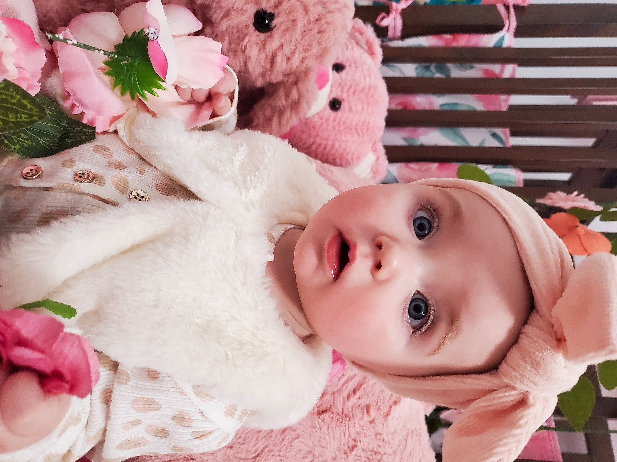 Aria is registered to the contest to win money with this photo: baby, baby_toddler_clothing, cheek, child, eye, eyelash, face, fur, happy, head, headgear, headwear, lip, nose, pattern, person, petal, pink, skin, surprise