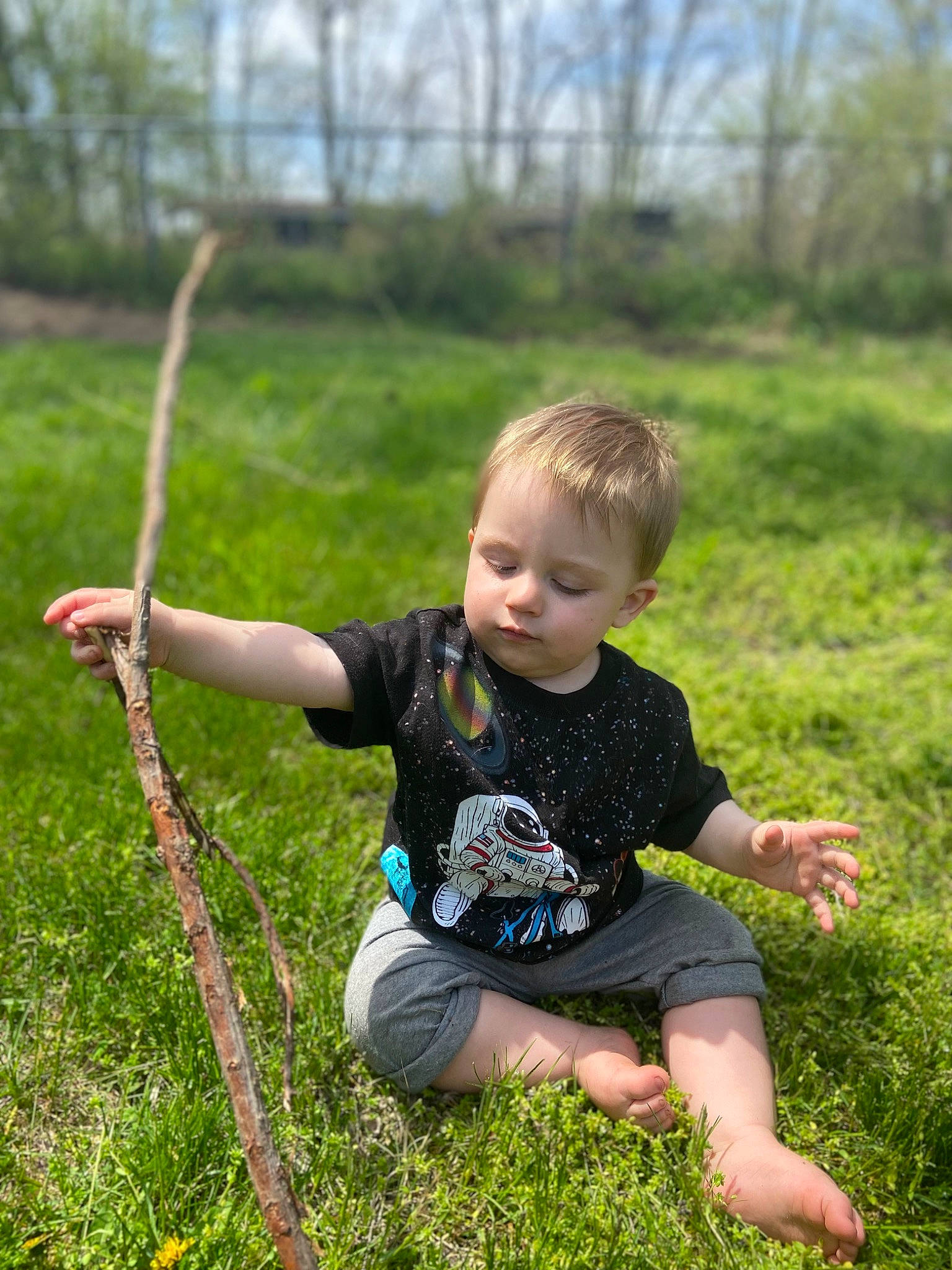 Evan is registered to the contest to win money with this photo: baby, baby_toddler_clothing, child, fun, grass, grass_family, grassland, happy, lawn, leisure, meadow, people_in_nature, person, plant, play, prairie, recreation, sitting, spring, t_shirt