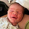 Colton is registered to the contest to win money with this photo: newborn, baby, infant, sleeping, smiling, face, skin, clothing, onesie, hand, arm, bottle, feeding, resting, cute, closeup, indoor, person, human, peaceful