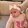 Amélia participe au concours pour gagner de l'argent avec cette photo : baby, bow, butterfly_print, casual_wear, child, couch, cozy, cushion, cute, family, hand, headband, indoor, infant, looking_away, person, pink_clothing, seated, soft_texture, toddler