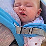 arm, baby, blue, buckle, carrier, cheeks, closeup, clothing, daylight, fabric, face, hand, infant, mouth_open, outdoor, person, skin, sleeping, star_pattern, strap
