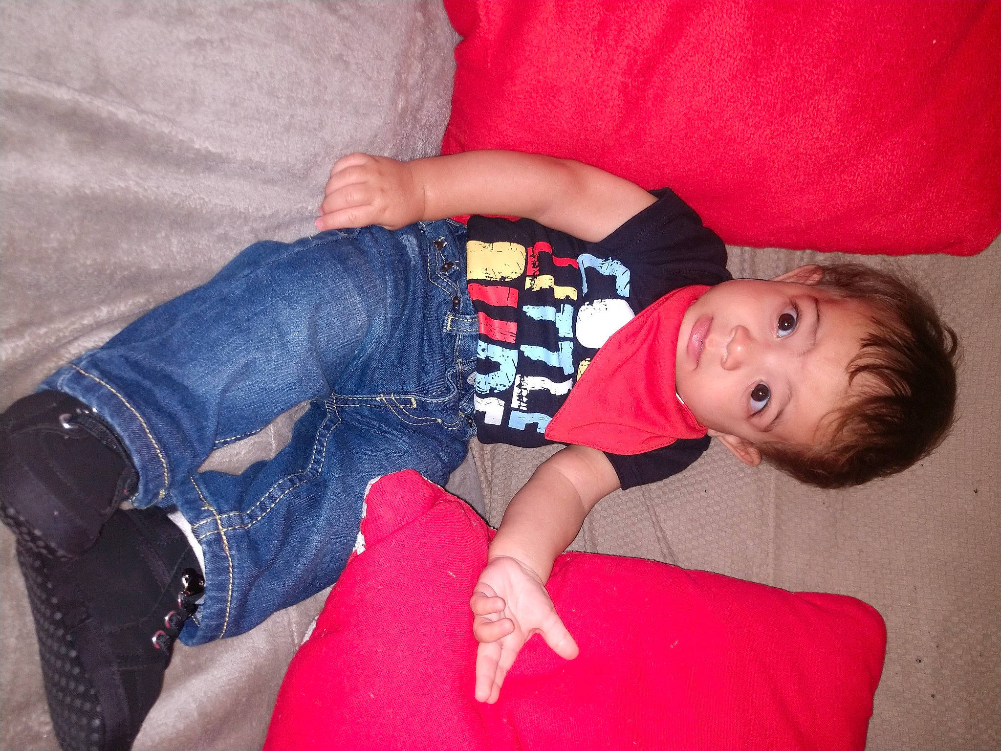 Claudio is registered to the contest to win money with this photo: arm, baby, baby_toddler_clothing, comfort, couch, eye, facial_expression, finger, flash_photography, human_body, joint, lap, leg, mouth, person, red, skin, sleeve, textile, thigh