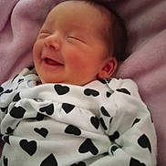 Makenna joined the competition — help win amazing prizes! baby, newborn, smiling, blanket, heart_pattern, sleeping, cozy, infant, cute, soft, clothing, portrait, peaceful, resting, face, head, pink, fabric, child, toddler