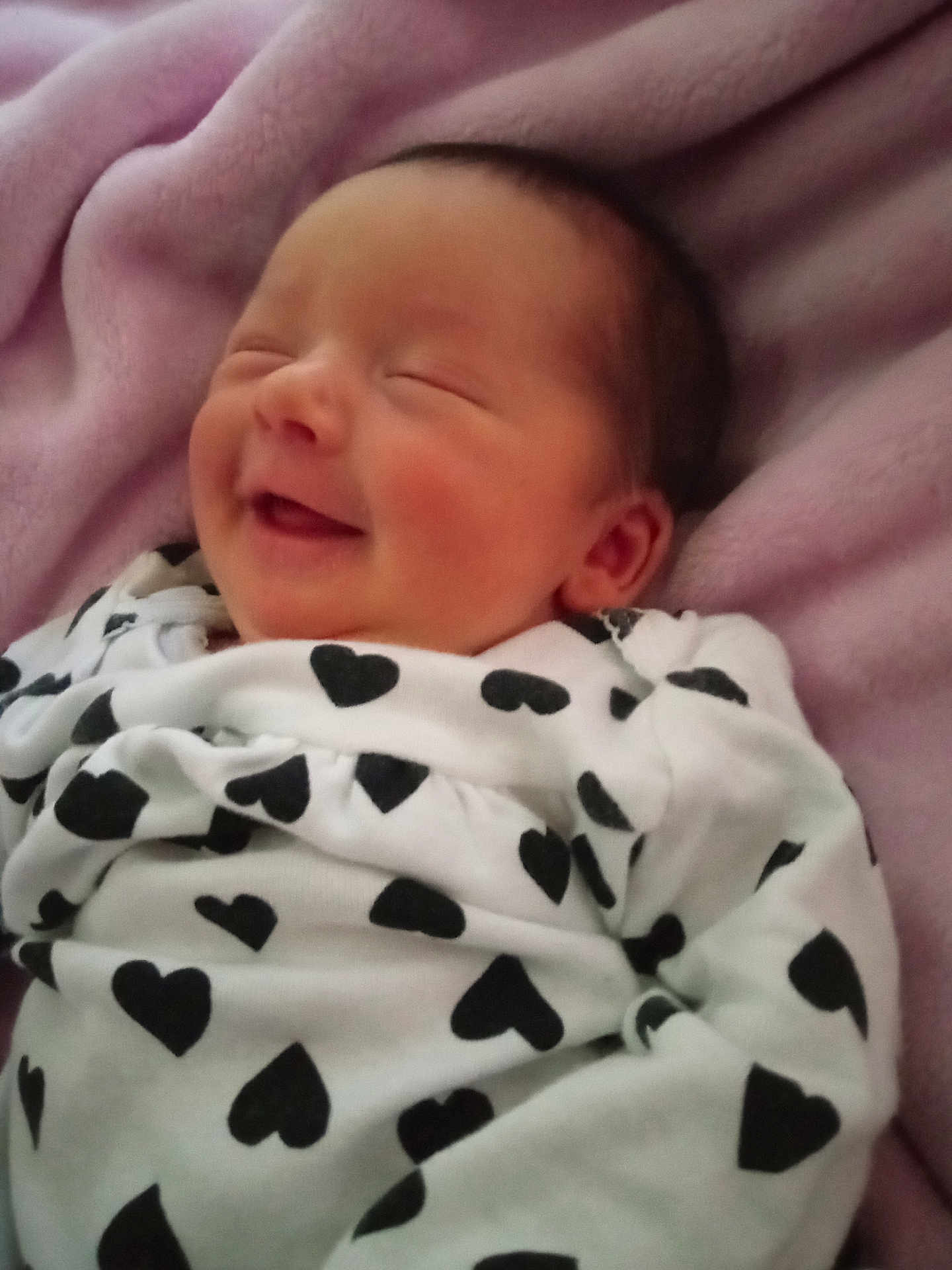 Makenna joined the competition — help win amazing prizes! baby, newborn, smiling, blanket, heart_pattern, sleeping, cozy, infant, cute, soft, clothing, portrait, peaceful, resting, face, head, pink, fabric, child, toddler