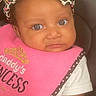 animal_print, baby, bow, car_seat, child, closeup, clothing, cute, expression, eyes, face, headband, indoors, infant, person, pink_bib, portrait, seat_belt, sitting, young_child