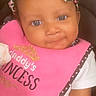 Annaniyah is registered to the contest to win money with this photo: adorable, baby, child, closeup, clothing, cute, face, happy, headband, indoor, infant, leopard_print, person, pink_bib, portrait, sitting, smiling, warning_label, white_shirt, young_child