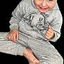 child, boy, smile, gray_tracksuit, sitting, barefoot, happy, portrait, casual_clothing, playful, young, person, childhood, cute, indoors, relaxed, fun, hair, face, skin