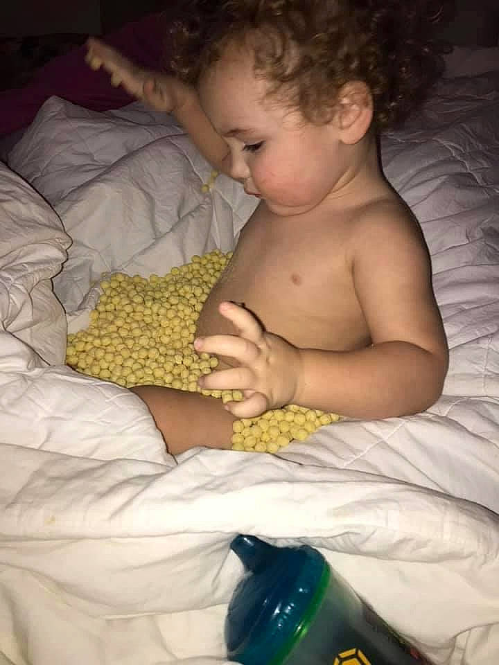 Jaxyn is registered to the contest to win money with this photo: baby, baby_toddler_clothing, bed, bed_sheet, bedding, bedtime, bottle, child, comfort, drink, ear, finger, glass_bottle, human, linens, mammal, nail, person, skin, sleep