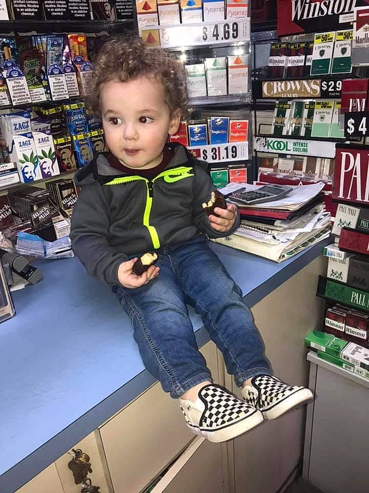 Jaxyn is registered to the contest to win money with this photo: baby, baby_toddler_clothing, book, box, collection, denim, outdoor_shoe, person, pocket, publication, retail, shelf, shelving, shoe, sitting, skate_shoe, toddler, trade, walking_shoe