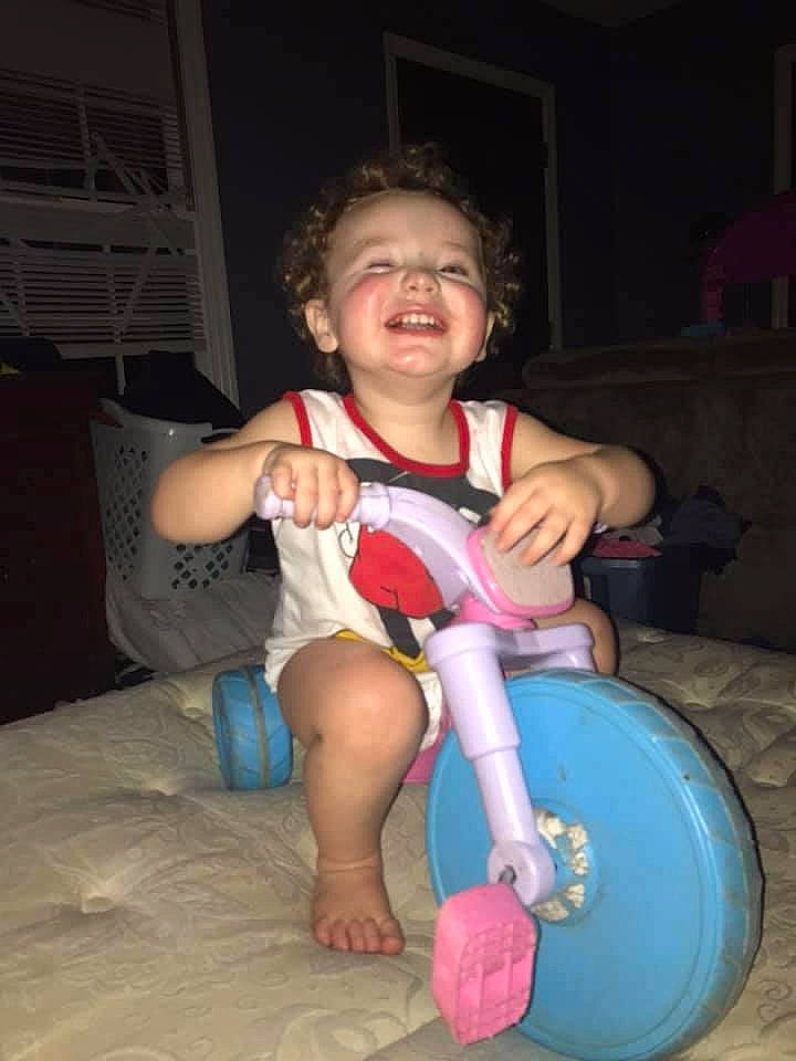 Jaxyn joined the competition — help win amazing prizes! ankle, baby, baby_toddler_clothing, balance, finger, foot, humour, joy, living_room, person, plastic, riding_toy, thumb, toddler, tooth, toy, tricycle