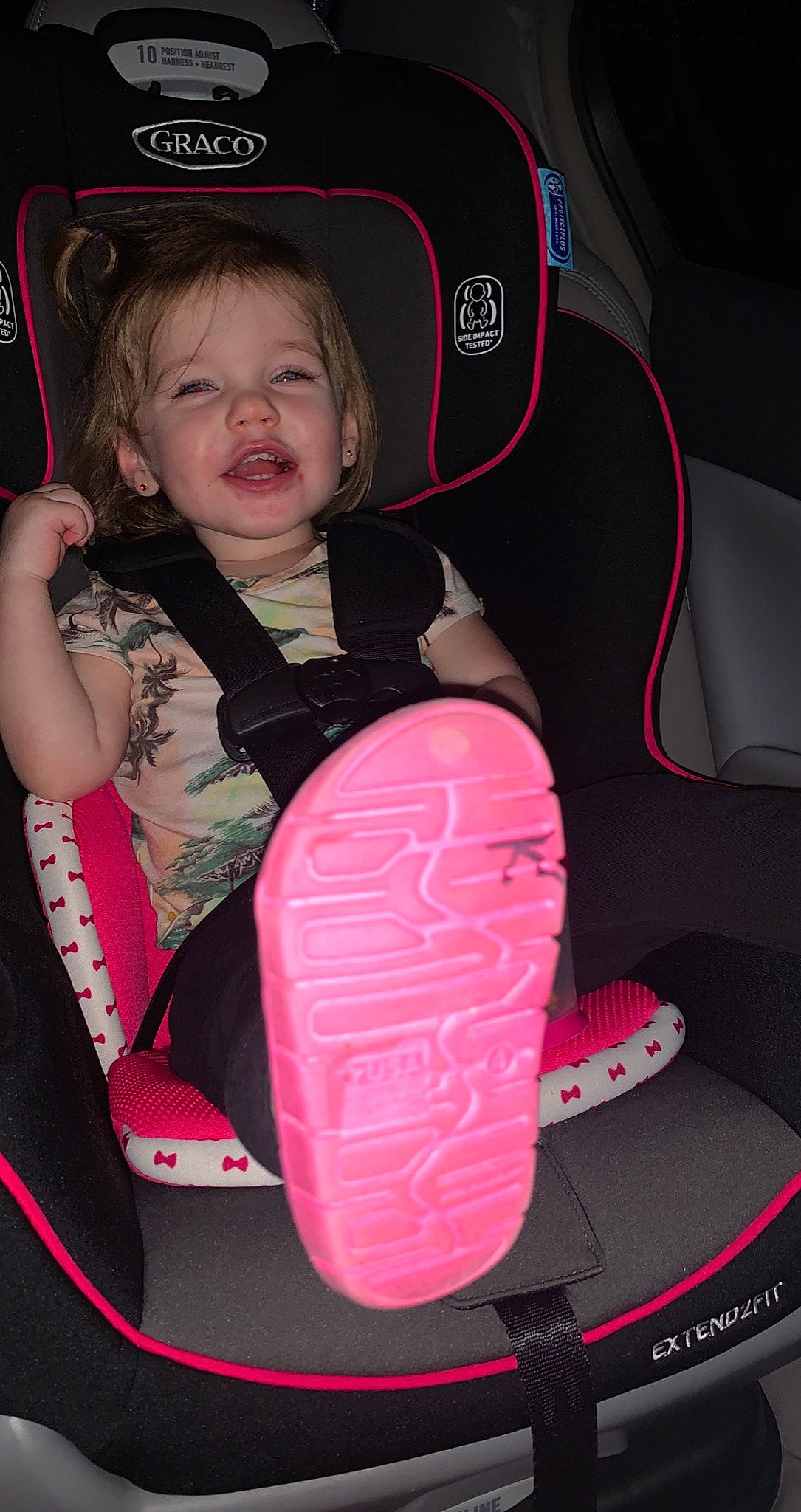 Kenzley is registered to the contest to win money with this photo: automotive_design, baby, baby_carriage, baby_in_car_seat, baby_toddler_clothing, bag, car_seat, car_seat_cover, comfort, fun, head, magenta, motor_vehicle, person, pink, smile, sneakers, steering_part, steering_wheel, toddler