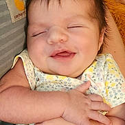 Aurora joined the competition — help win amazing prizes! baby, smiling, sleeping, infant, arms, blanket, clothing, person, cute, happy, closeup, face, head, hair, skin, hand, toddler, resting, comfort, warmth