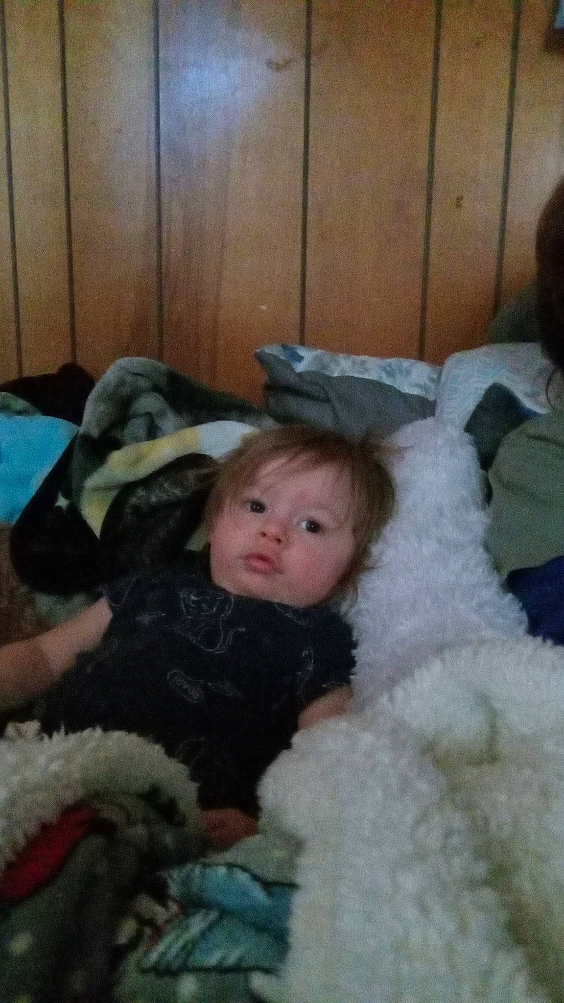 Clayton is registered to the contest to win money with this photo: baby, baby_toddler_clothing, child, comfort, eye, fun, fur, fur_clothing, lap, mammal, natural_material, person, room, sitting, skin, toddler, vertebrate, winter, wood, wool