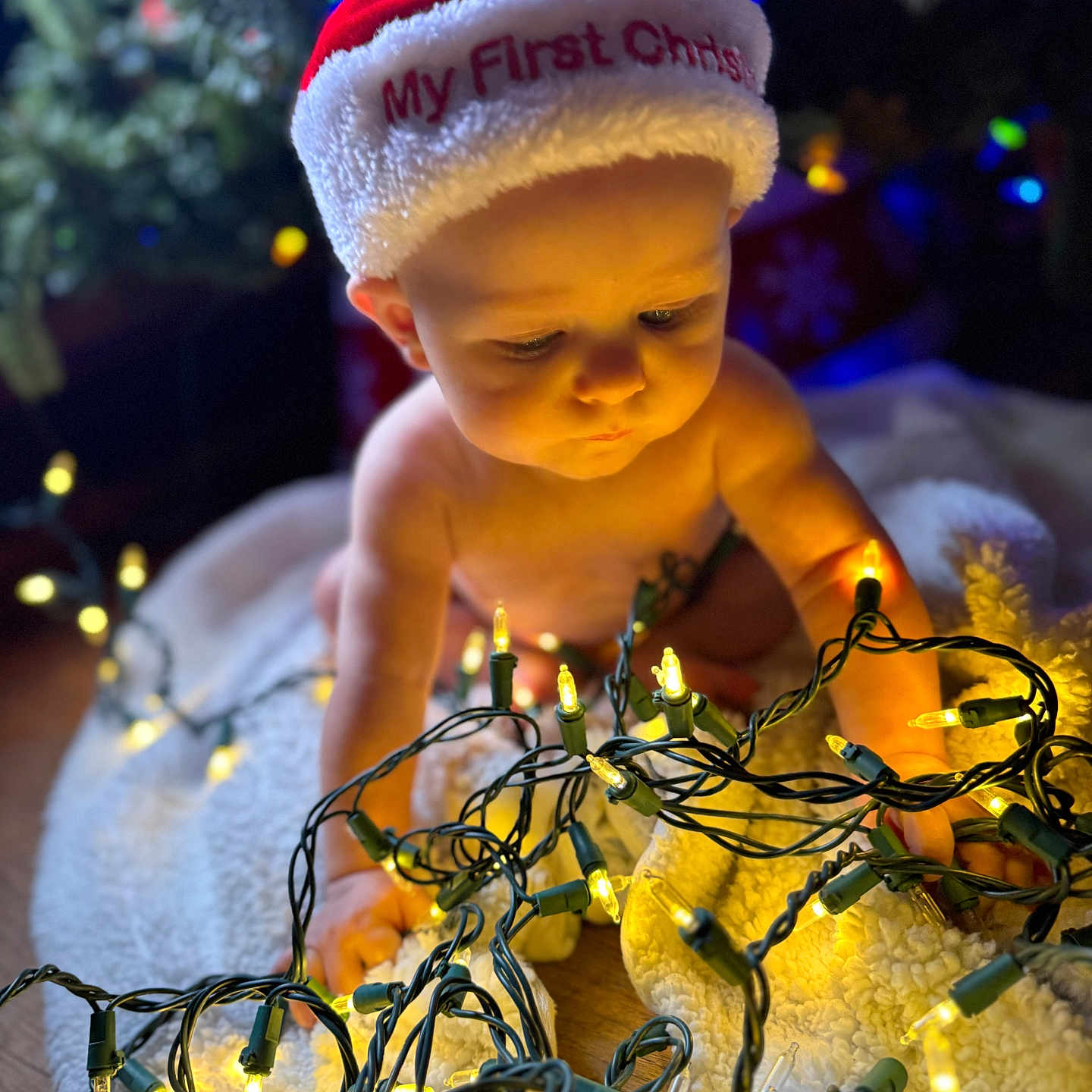 Jacoby is registered to the contest to win money with this photo: baby, beanie, bodypart, bonnet, cap, clothing, cream, dessert, face, festival, finger, hand, hanukkahmenorah, hat, head, lighting, person, photography, portrait, sphere