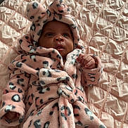 Alaia joined the competition — help win amazing prizes! baby, infant, pink, robe, leopard_print, hood, ears, bed, quilt, blanket, soft, cute, cozy, clothing, child, person, lying_down, indoor, portrait, warm