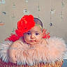baby, infant, child, portrait, headband, flower, red_flower, feathers, pink, basket, sitting, looking_at_camera, calm, face, eyes, indoor, studio, backdrop, photography, costume