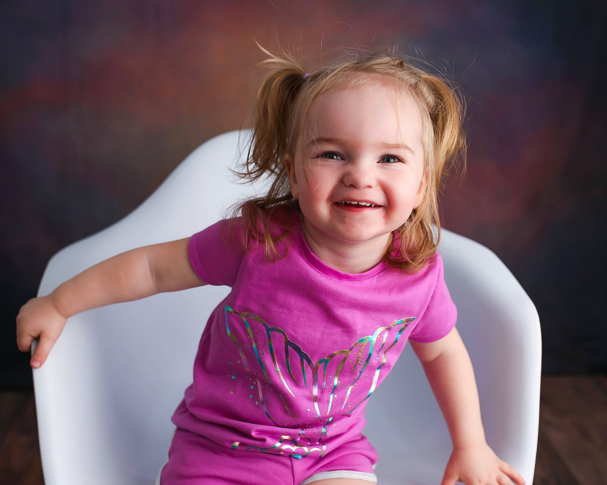 Jordyn is registered to the contest to win money with this photo: arm, baby_toddler_clothing, cheek, dress, face, facial_expression, flash_photography, hair, happy, head, human_body, iris, joy, lip, neck, people_in_nature, person, purple, shoulder, skin