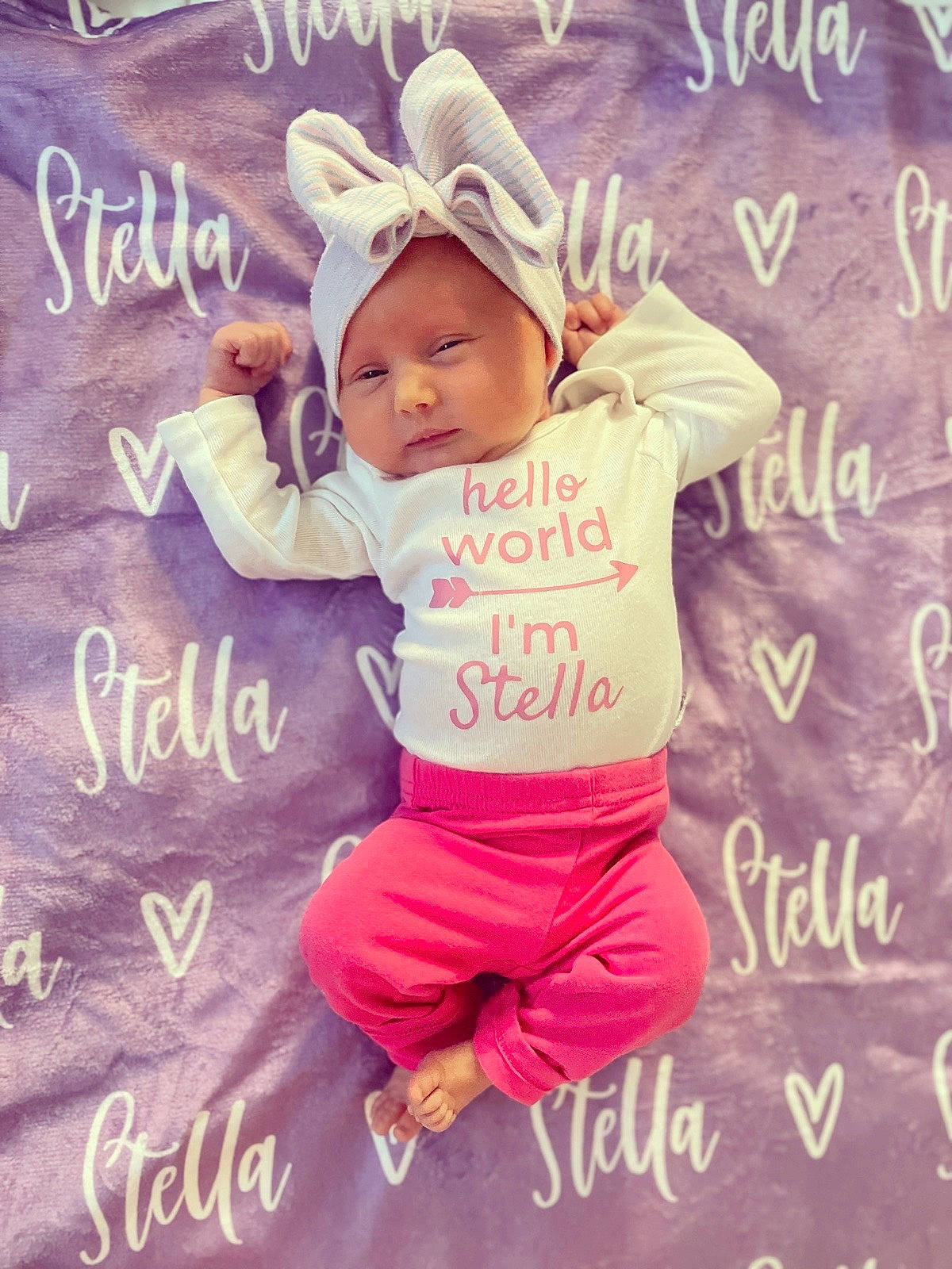 Stella is registered to the contest to win money with this photo: baby, baby_toddler_clothing, blackboard, cap, chalk, child, cloud, cool, font, gesture, handwriting, happy, hat, headwear, magenta, pattern, person, photo_caption, pink, sleeve