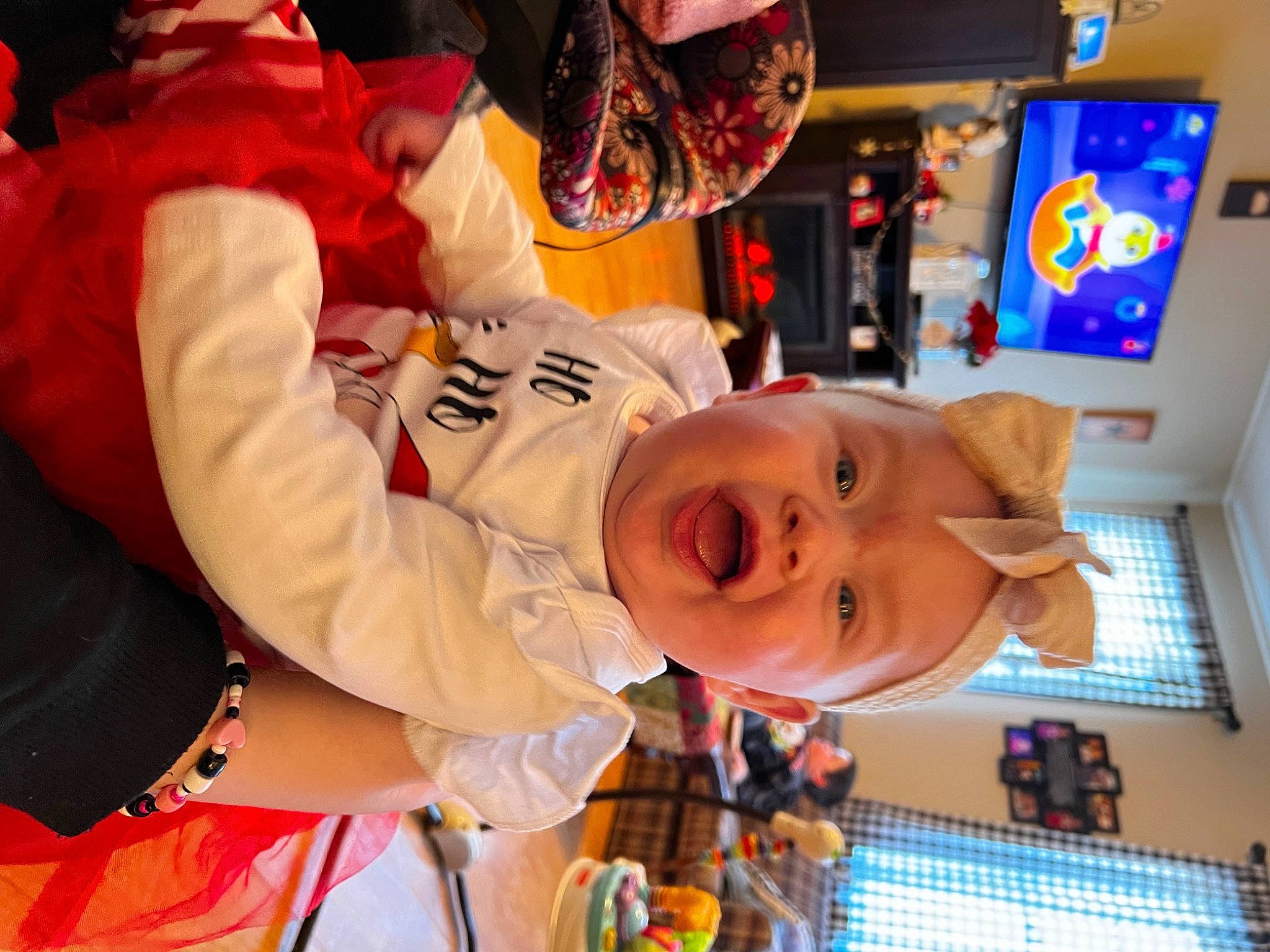 Lakelyn is registered to the contest to win money with this photo: baby, child, costume, event, fun, glove, happy, hat, holiday, leisure, orange, party, person, recreation, room, smile, t_shirt, toddler, tradition, tree