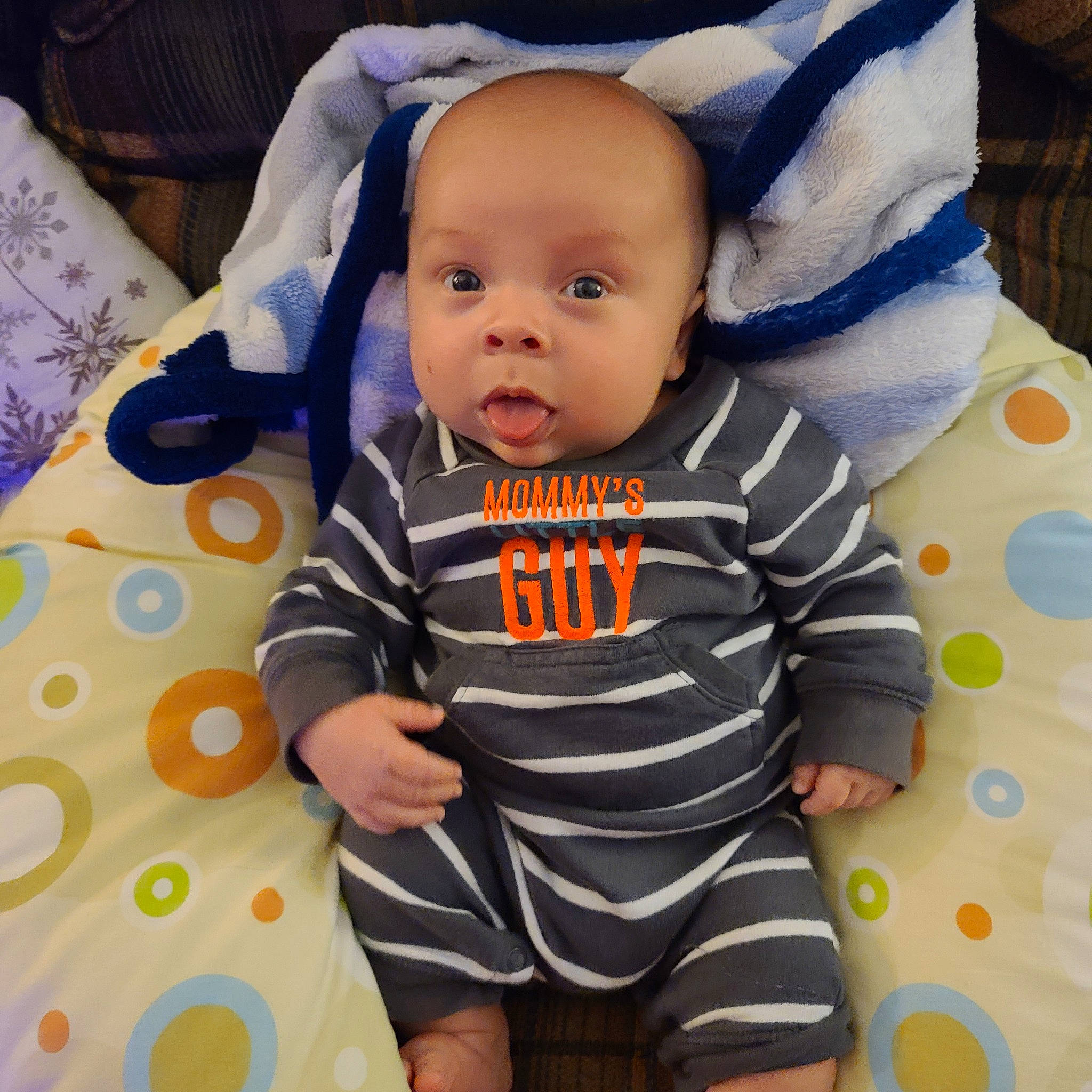 Gabriel is registered to the contest to win money with this photo: baby, baby_products, baby_safety, baby_toddler_clothing, child, linens, nightwear, pattern, person, polka_dot, product, sleeve, surprise, toddler