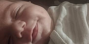 Braylen joined the competition — help win amazing prizes! baby, sleeping, close_up, face, infant, smile, peaceful, cozy, white_clothing, newborn, soft_light, portrait, cute, rest, young_child, skin, button, fabric, head, calm