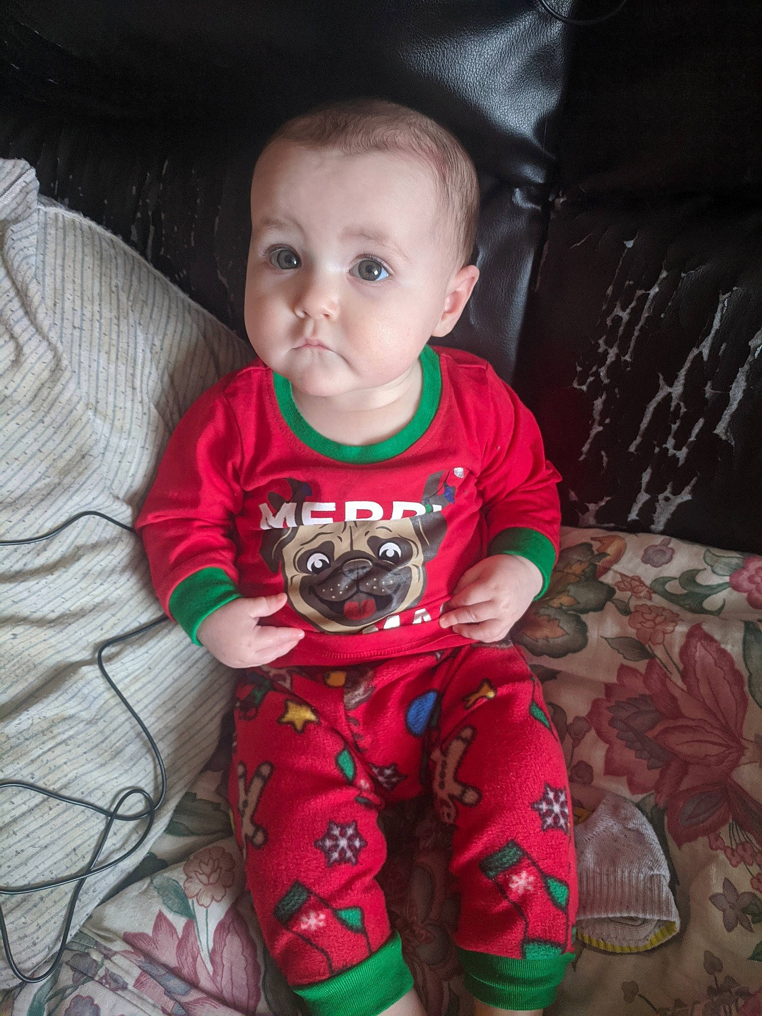 Adelaide is registered to the contest to win money with this photo: arm, baby, cheek, child, christmas, cool, electronic_device, eye, fictional_character, glasses, head, leg, mouth, pajamas, person, sitting, skin, sleeve, smile, technology