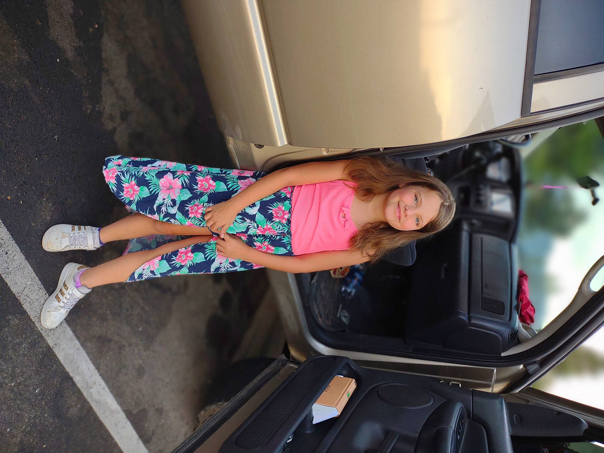 Maycee is registered to the contest to win money with this photo: auto_part, automotive_design, automotive_exterior, automotive_lighting, automotive_tire, bumper, calf, dress, fun, hood, human_leg, joint, joy, knee, motor_vehicle, person, pink, smile, thigh, tire