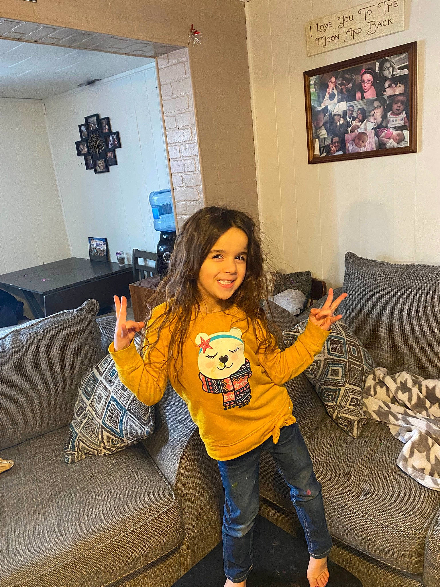Camie is registered to the contest to win money with this photo: comfort, couch, floor, flooring, furniture, happy, human_leg, interior_design, joy, knee, living_room, person, picture_frame, pillow, room, smile, sofa_bed, sportswear, studio_couch, t_shirt