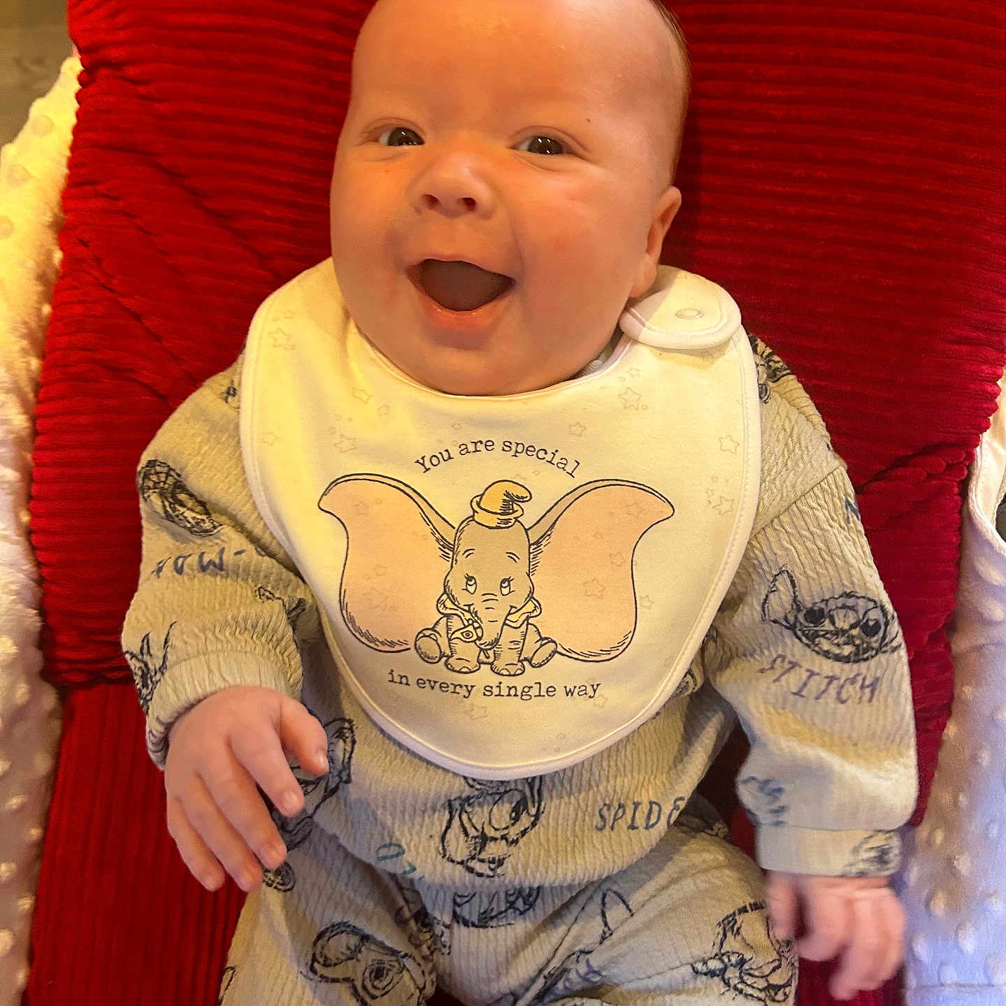 Tommy is registered to the contest to win money with this photo: baby, babylaughing, bib, bodypart, chair, clothing, couch, cushion, face, furniture, happy, head, homedecor, laughing, mouth, newborn, pajamas, pants, person, photography