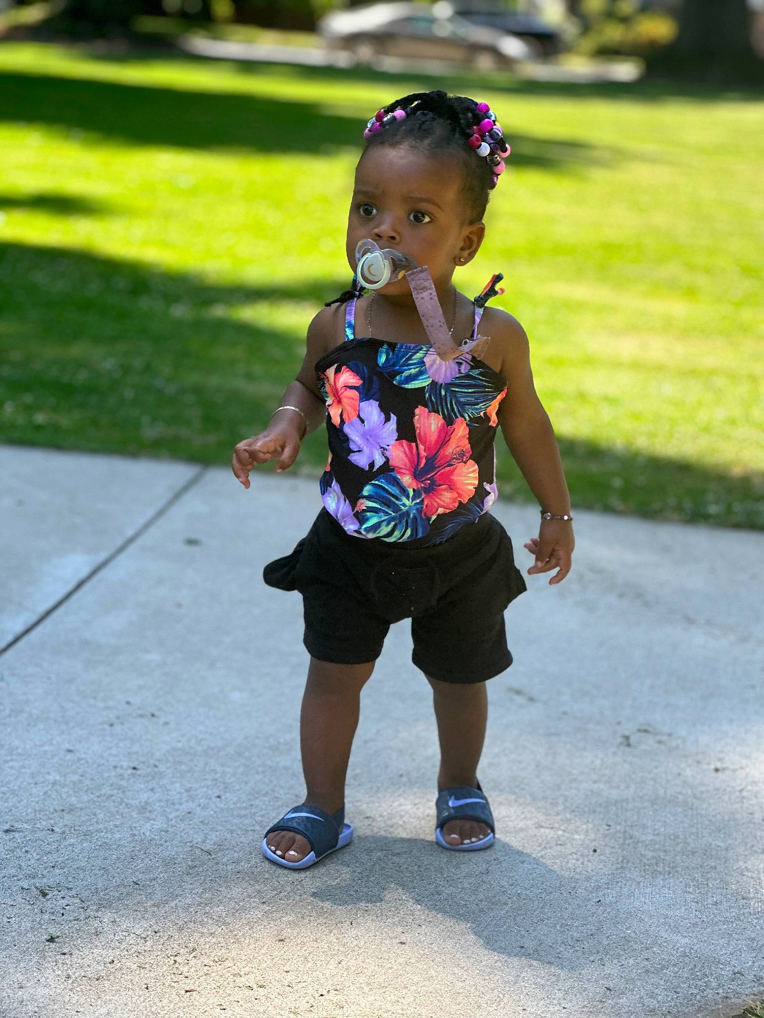 La Raya is registered to the contest to win money with this photo: asphalt, electric_blue, footwear, fun, grass, happy, head, human_leg, leisure, magenta, mammal, person, plant, public_space, recreation, road, shorts, t_shirt, thigh, toddler