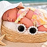 baby, sleeping, hat, sunglasses, basket, beach, sand, starfish, seashell, colorful_clothing, cute, peaceful, summer, outdoor, infant, resting, sunhat, accessories, relaxation, portrait