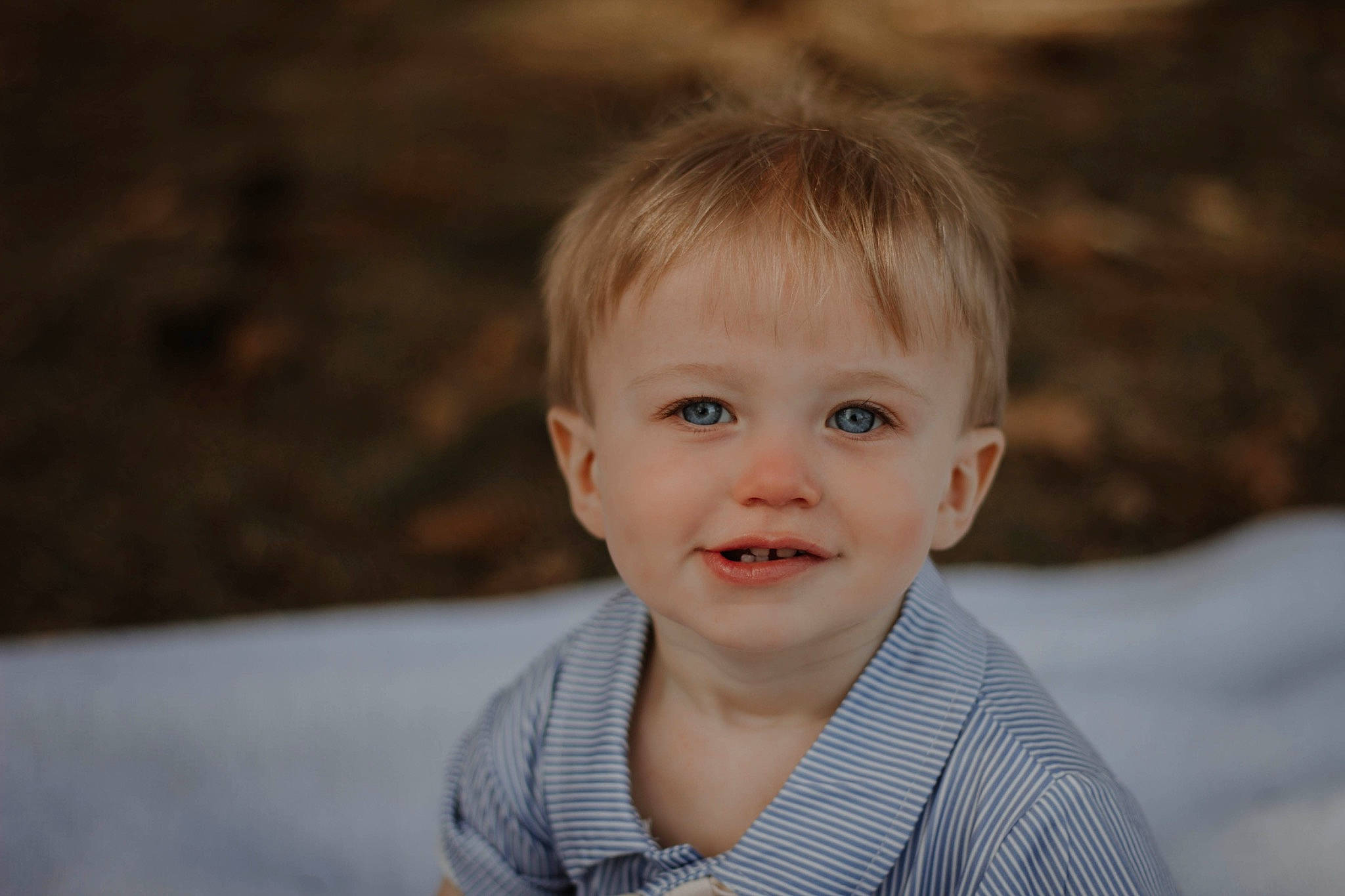 Michael is registered to the contest to win money with this photo: baby, baby_toddler_clothing, cheek, child, eyebrow, face, flash_photography, fun, grass, happy, iris, joy, nose, person, plant, portrait_photography, sleeve, smile, t_shirt, toddler