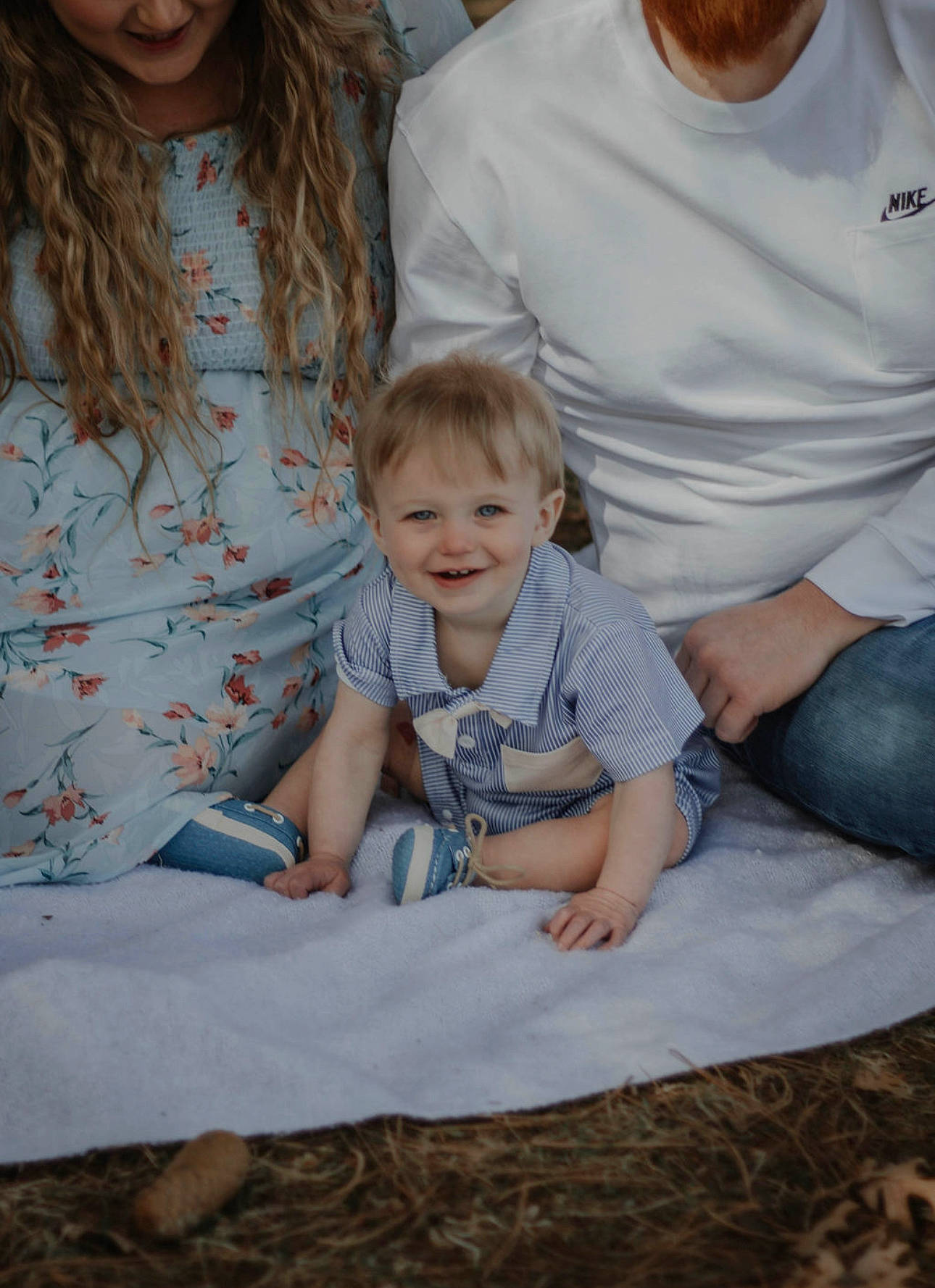 Michael is registered to the contest to win money with this photo: baby, baby_toddler_clothing, child, comfort, event, flooring, fun, grass, hairstyle, happy, interaction, joy, lap, pattern, person, sitting, sleeve, smile, standing, t_shirt