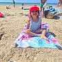 Séréna participe au concours pour gagner de l'argent avec cette photo : child, beach, sand, towel, hat, smiling, sunny, swimsuit, sea, water, summer, people, shore, rocks, footwear, basket, blue_sky, vacation, outdoor, holiday