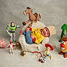 Milan joined the competition — help win amazing prizes! baby, infant, child, smiling, sitting, chair, toys, toy_story, buzz_lightyear, woody, rex, hamm, bullseye, mr_potato_head, jessie, forky, piggy_bank, indoor, portrait, colorful