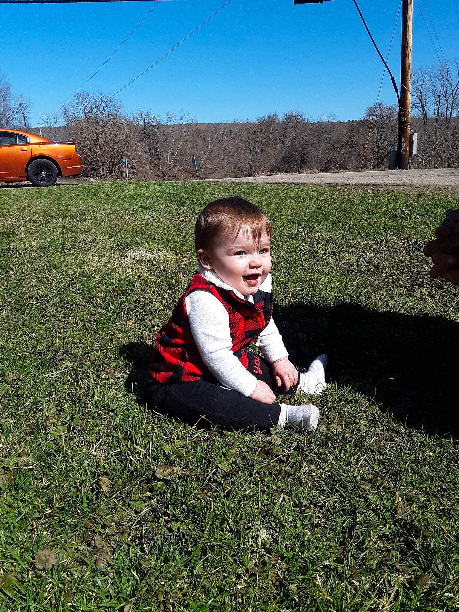 Kaylin is registered to the contest to win money with this photo: car, child, grass, grass_family, grassland, home, lawn, leaf, mountain, person, plant, play, sitting, sky, spring, toddler, tree, vacation, vehicle