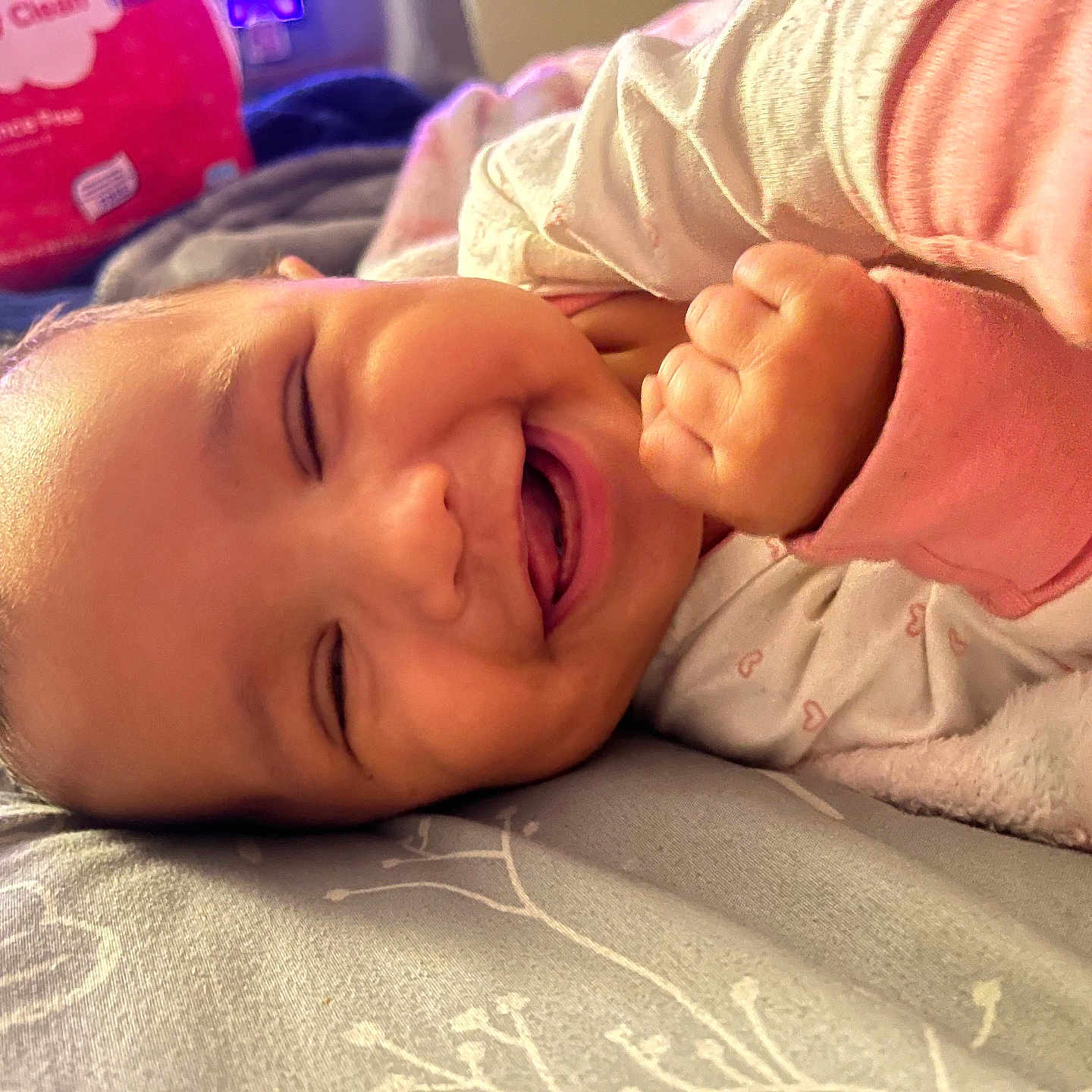 Avyanna joined the competition — help win amazing prizes! baby, infant, child, crying, sleeping, lying_down, face, fist, hand, onesie, pink_clothing, blanket, bed, bedding, home, indoor, portrait, close_up, cozy, candid