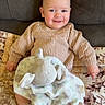 Waylon joined the competition — help win amazing prizes! baby, smiling, knitted_sweater, plush_toy, elephant, blanket, couch, patterned_blanket, happy, infant, child, indoors, cozy, cute, toddler, person, sitting, soft_toy, warm, comfort