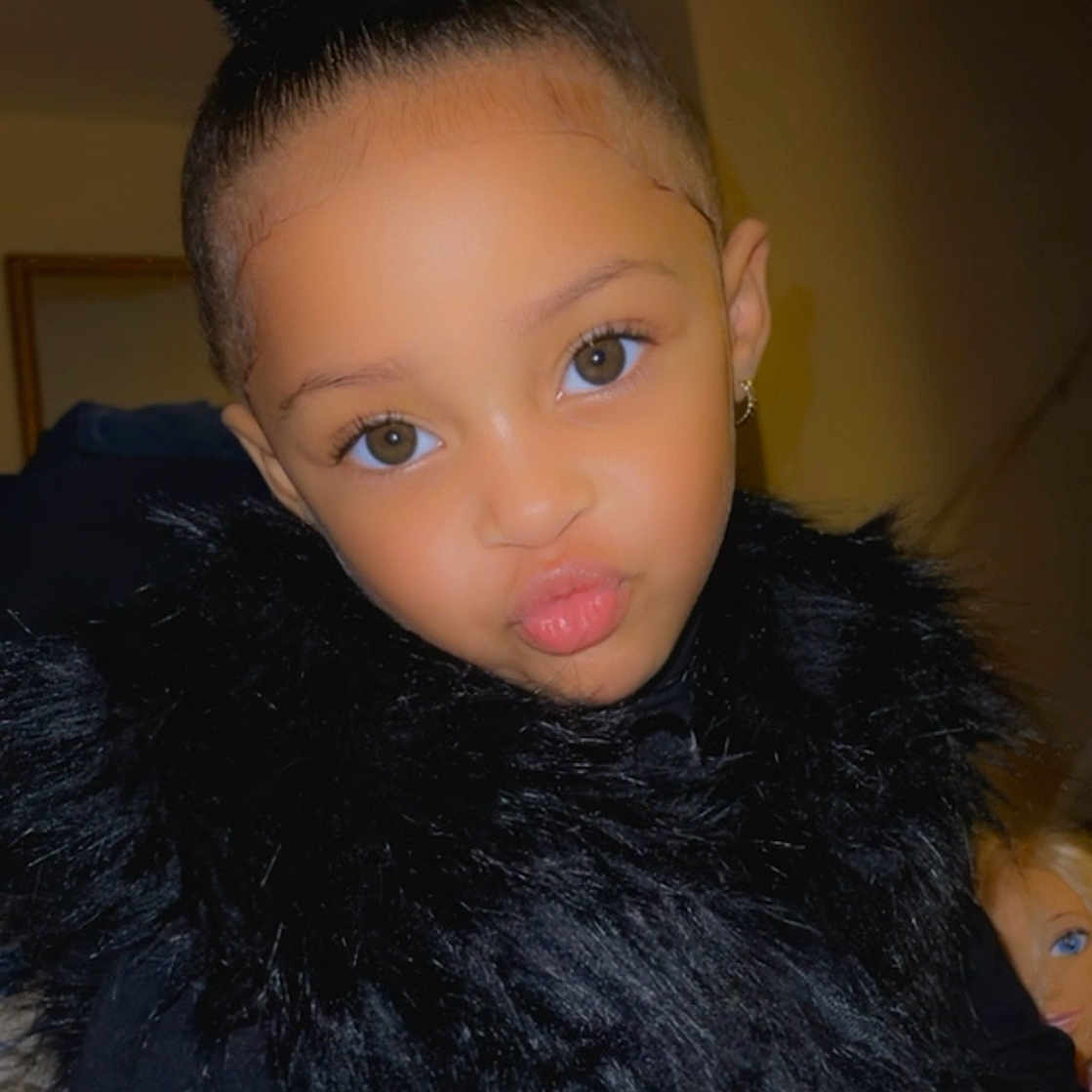 Myara is registered to the contest to win money with this photo: black_clothing, bun, child, confidence, cute, earring, expression, eyes, face, fashion, fur, hairstyle, indoor, person, portrait, pose, pout, skin, smile, young