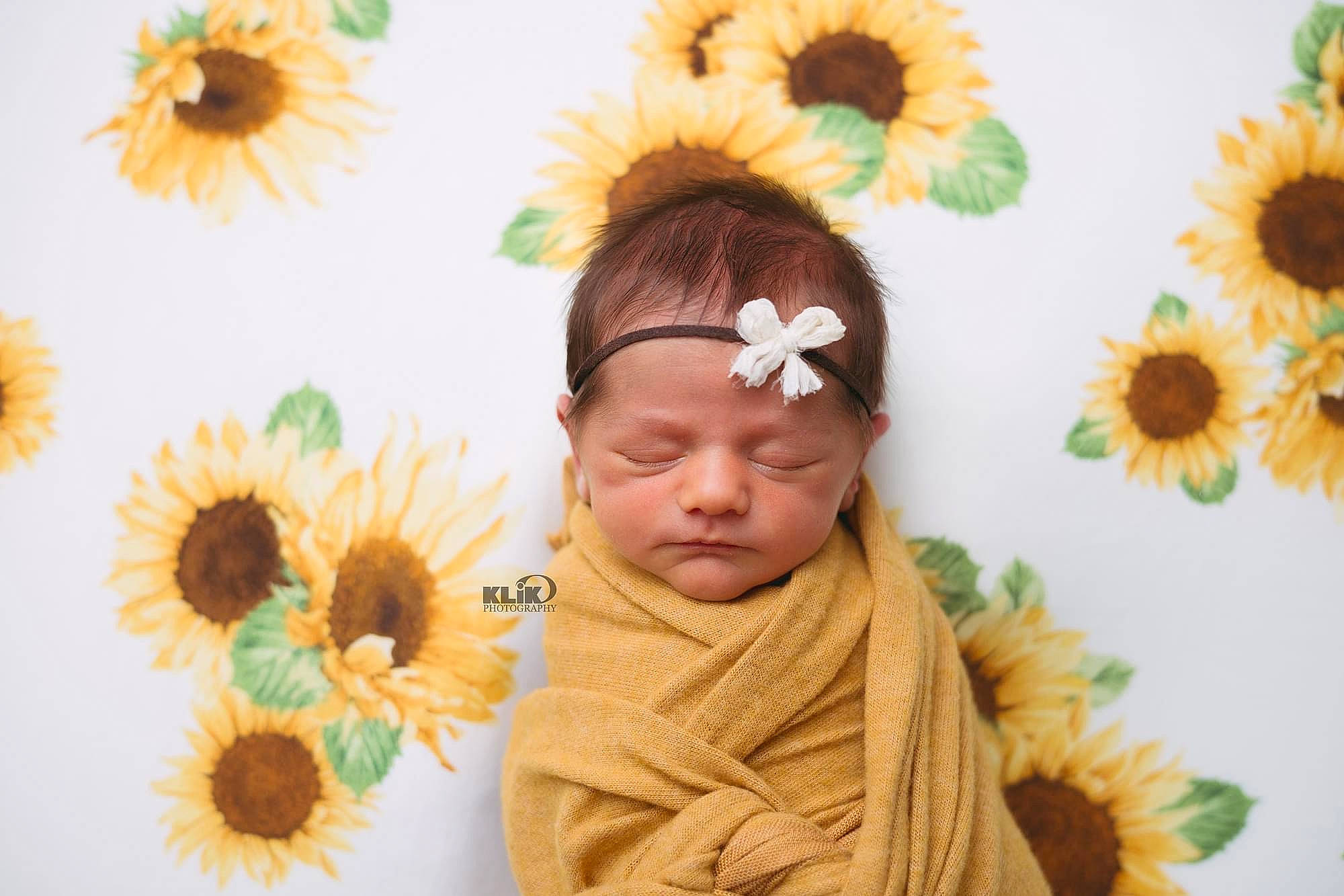 Evelyn is registered to the contest to win money with this photo: adaptation, beauty, eyelash, floral_design, flower, green, happy, head, headgear, iris, leaf, nature, orange, people_in_nature, person, petal, plant, summer, textile, toddler