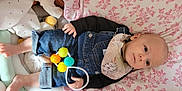 Soan participe au concours pour gagner de l'argent avec cette photo : baby, bed, bodypart, candy, clothing, couch, face, finger, food, furniture, hand, head, hosiery, jeans, pants, person, photography, portrait, sock, sweets