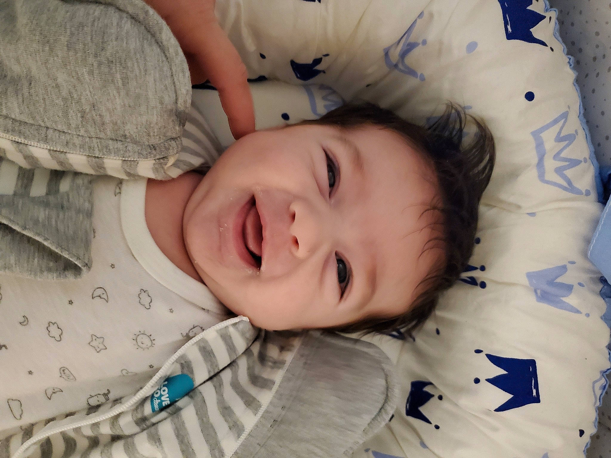 Cesar is registered to the contest to win money with this photo: baby, baby_toddler_clothing, cheek, child, comfort, cool, eyebrow, face, finger, happy, iris, lip, nose, pattern, people, person, skin, sleeve, smile, textile