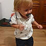 active, baby, blond_hair, cabinet, child, cute, floor, furniture, home, indoor, motion_blur, pacifier, person, shorts, smile, toddler, walking, white_shirt, wooden_floor, young_child