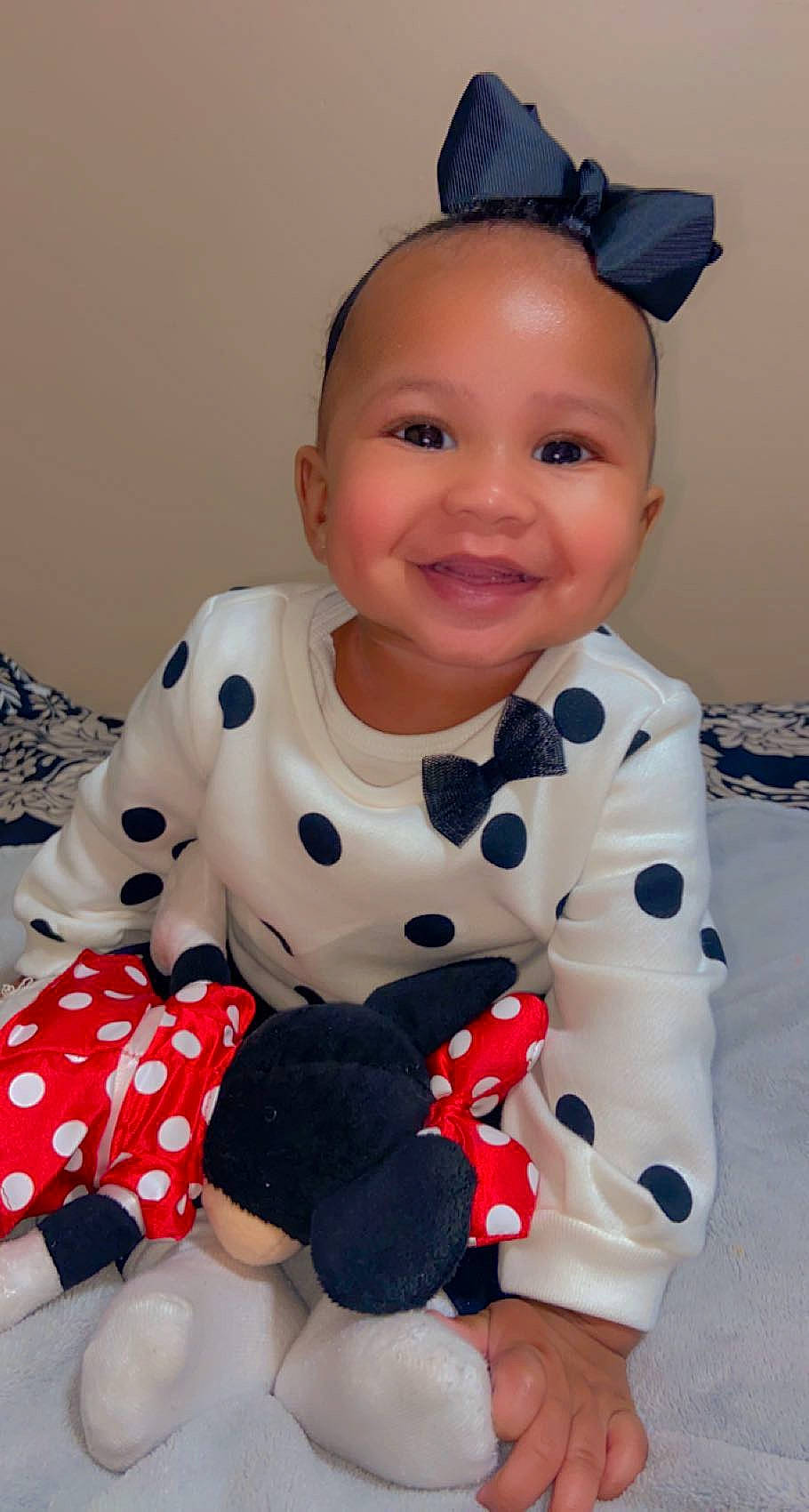 Amyra is registered to the contest to win money with this photo: arm, baby, baby_toddler_clothing, blue, cheek, comfort, face, finger, flooring, fun, happy, head, joy, pattern, person, pink, skin, sleeve, smile, t_shirt