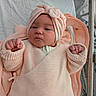 baby, infant, child, knitwear, headwrap, peach, clothing, fist, blanket, bed, portrait, indoor, newborn, cute, person, cozy, soft, warm, face, expression