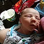 Landon is registered to the contest to win money with this photo: baby, newborn, sleeping, infant, onesie, hand, food, dip, chips, snack, person, indoor, clothing, face, peaceful, closeup, candid, rest, soft, casual